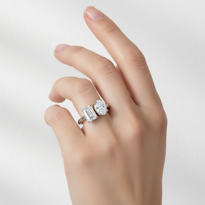 White gold two-stone ring with emerald-cut and oval diamond on model