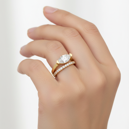 Yellow gold oval diamond bypass engagement ring with pavé band on model