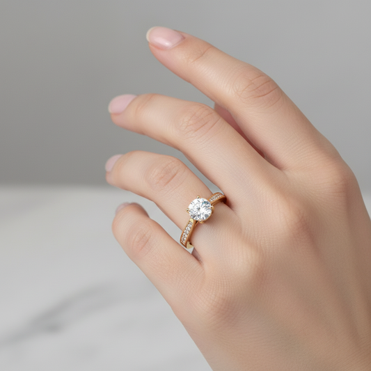 Yellow gold round brilliant diamond engagement ring with channel-set pavé band on model