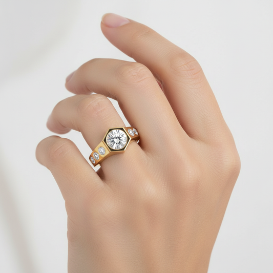Yellow gold round brilliant diamond engagement ring with hexagonal bezel setting and flush-set diamond accents on model