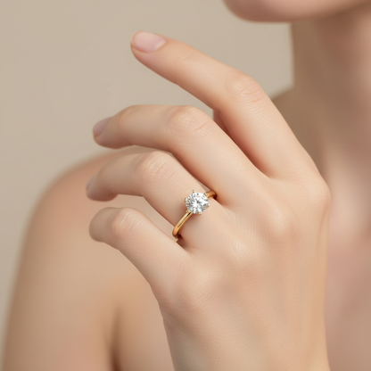 Yellow gold round brilliant diamond solitaire engagement ring on model