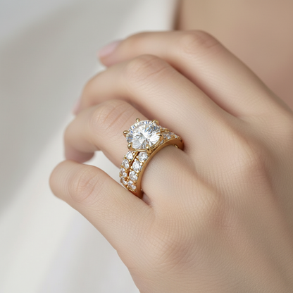 Yellow gold round brilliant diamond solitaire engagement ring with pavé band on model