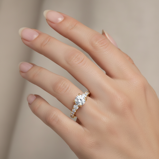 Yellow gold round brilliant diamond three-stone engagement ring with pavé band on model